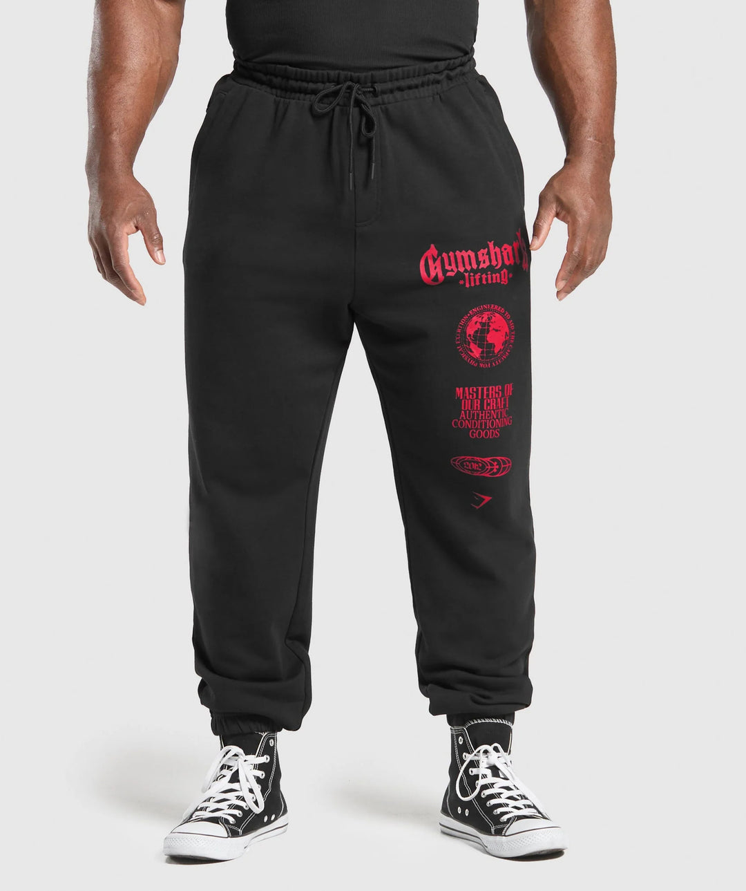 Men's tapered cotton fleece sweatpants with an elastic drawstring waistband, ribbed leg openings, and large logo print Mune Fashion