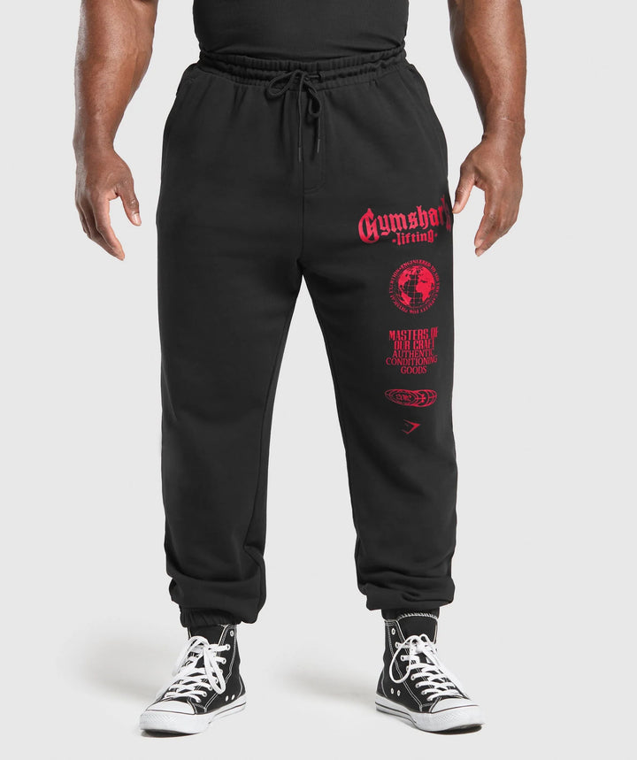 Men's tapered cotton fleece sweatpants with an elastic drawstring waistband, ribbed leg openings, and large logo print Mune Fashion
