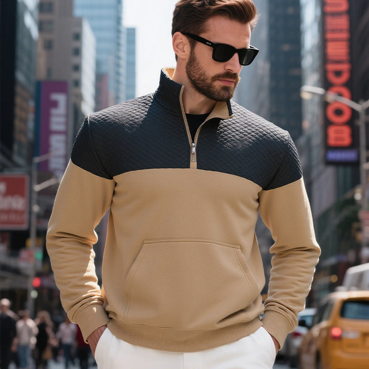 Men's color block half zip sweatshirt with quilted chest area, kangaroo pocket, and elastic cuffs Mune Fashion
