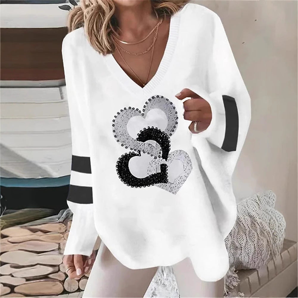 Women's oversized knitted sweater with deep neckline sequin heart and contrast sleeve stripes Mune Fashion