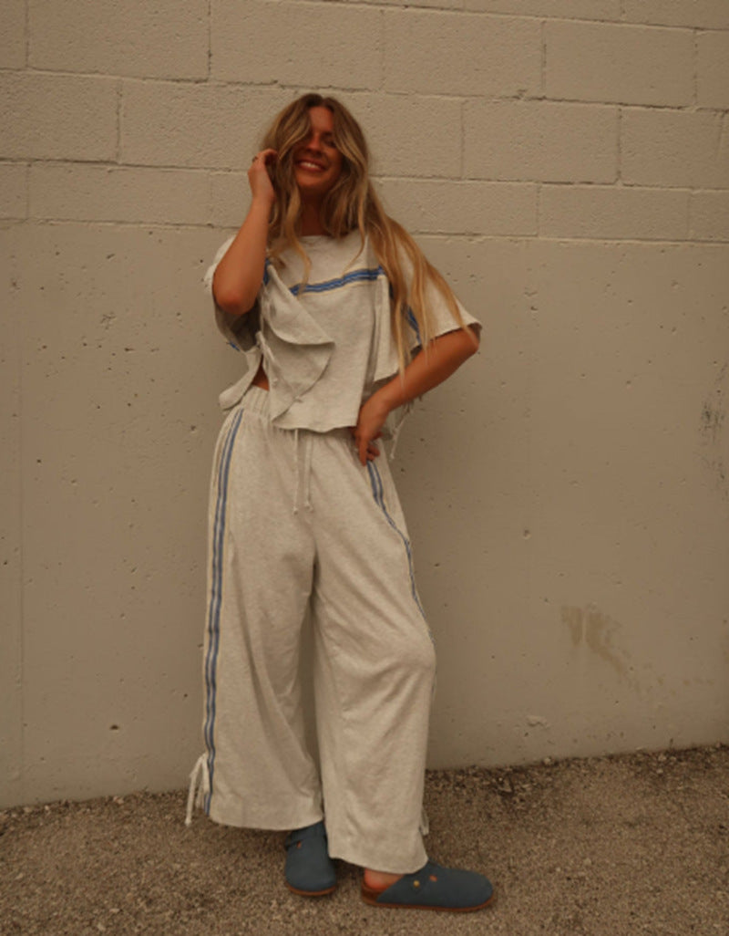 Ladies two-piece leisure ensemble with boxy ruffle top and wide cord pants with side decorative stripe Mune Fashion