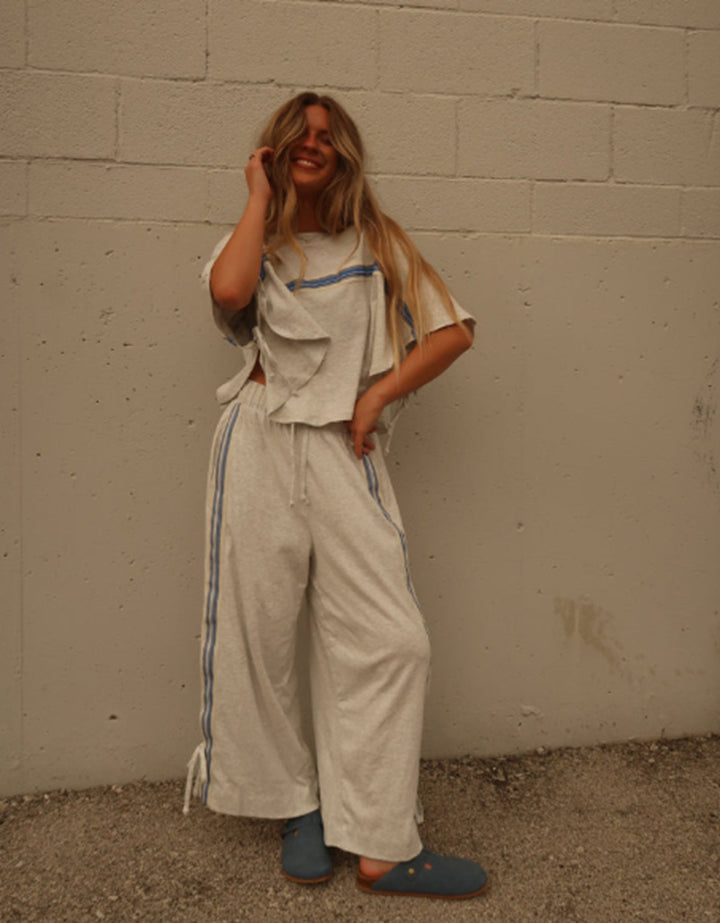 Ladies two-piece leisure ensemble with boxy ruffle top and wide cord pants with side decorative stripe Mune Fashion