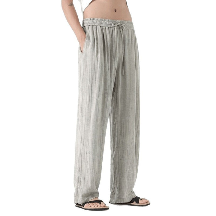 Men's loose linen trousers with adjustable drawstring waistband, casual pleat look, and side pockets Mune Fashion