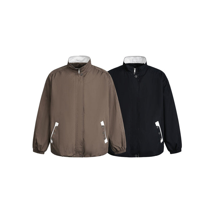 Unisex short-cut lightweight windbreaker jacket with standing collar, concealed zipper, and contrasting patch pockets Mune Fashion