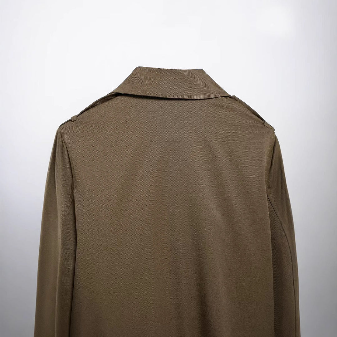 Women's short cropped trench coat in boxy cut with double-breasted button placket, shoulder epaulets and adjustable sleeve straps Mune Fashion