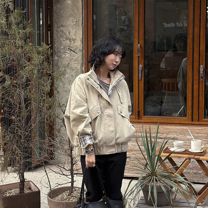 Women’s short bomber jacket with stand-up collar, chin strap, and checkered sleeve lining Mune Fashion