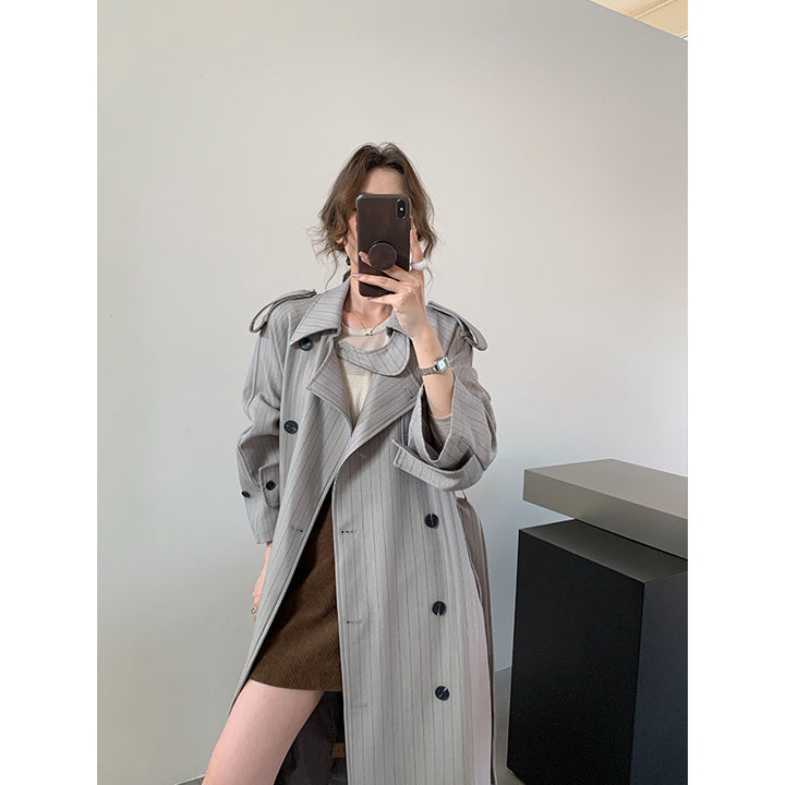 Women's pinstripe trench coat with boxy silhouette, shoulder patches, and concealed tie belt Mune Fashion