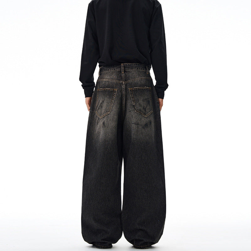 Men's loosely cut denim pants in floor-length baggy style with subtle paint splatter look Mune Fashion