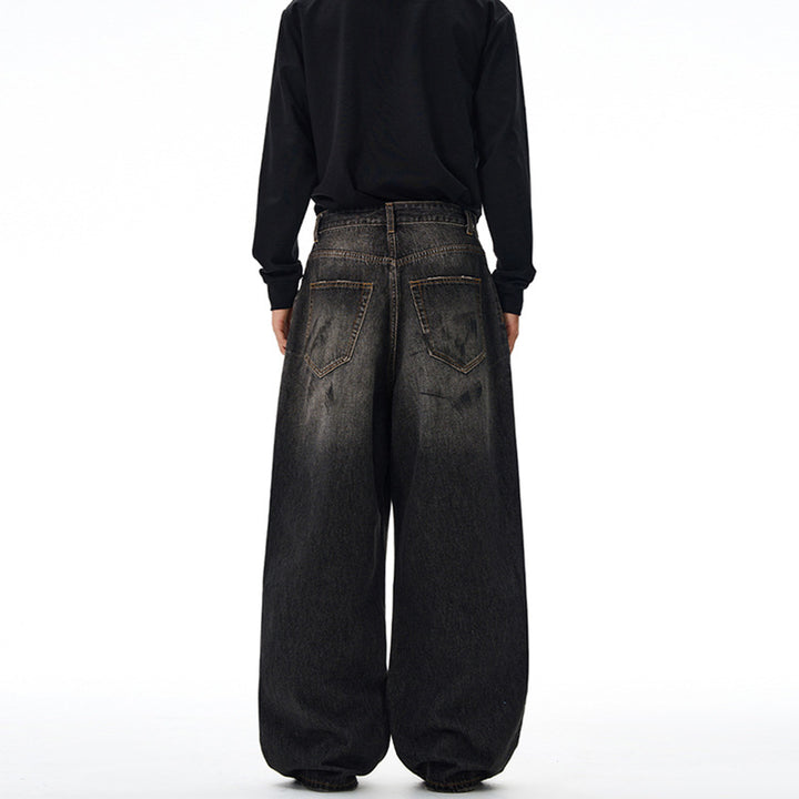 Men's loosely cut denim pants in floor-length baggy style with subtle paint splatter look Mune Fashion