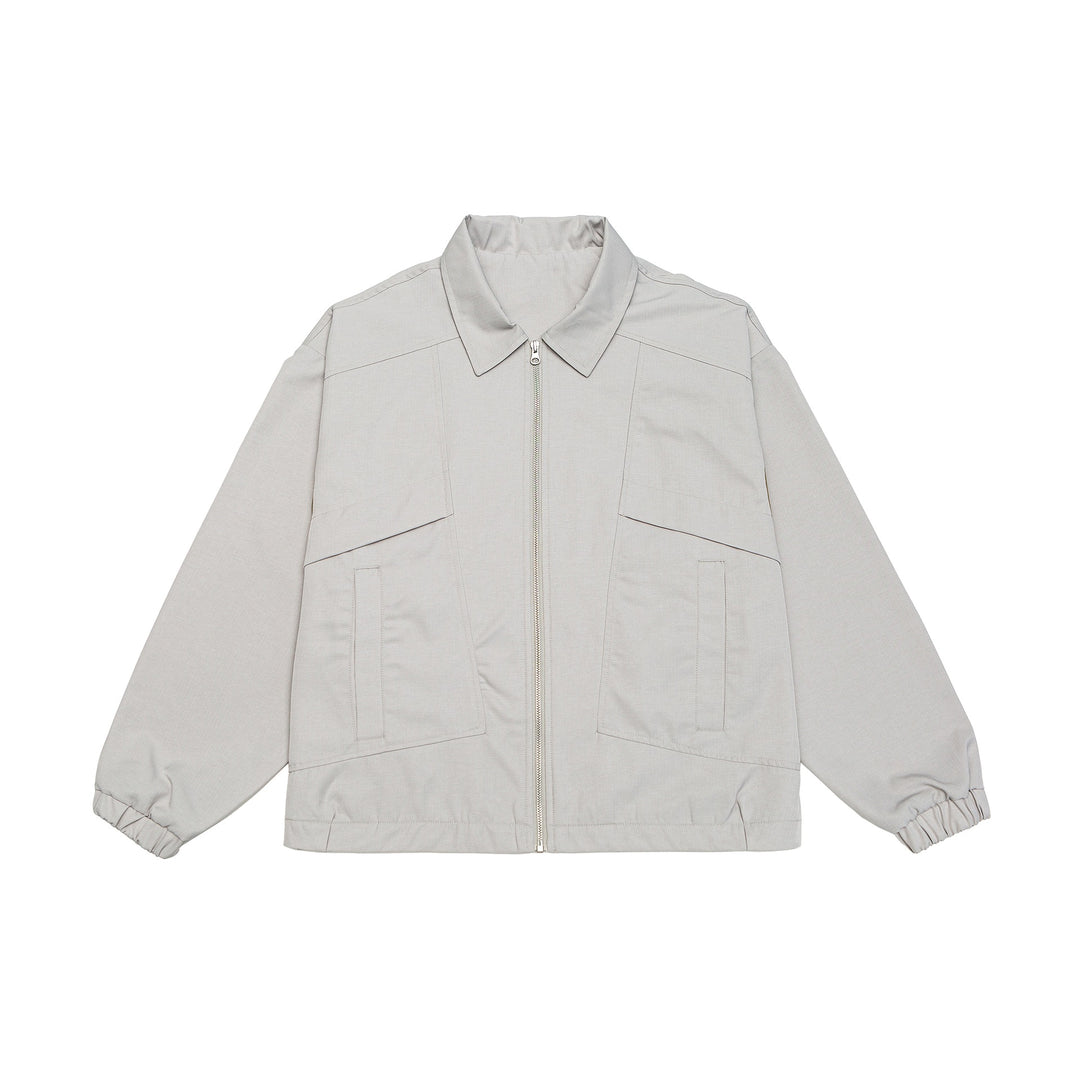 Unisex short jacket in boxy cut with shirt collar, visible metal zipper and utility patch pockets Mune Fashion