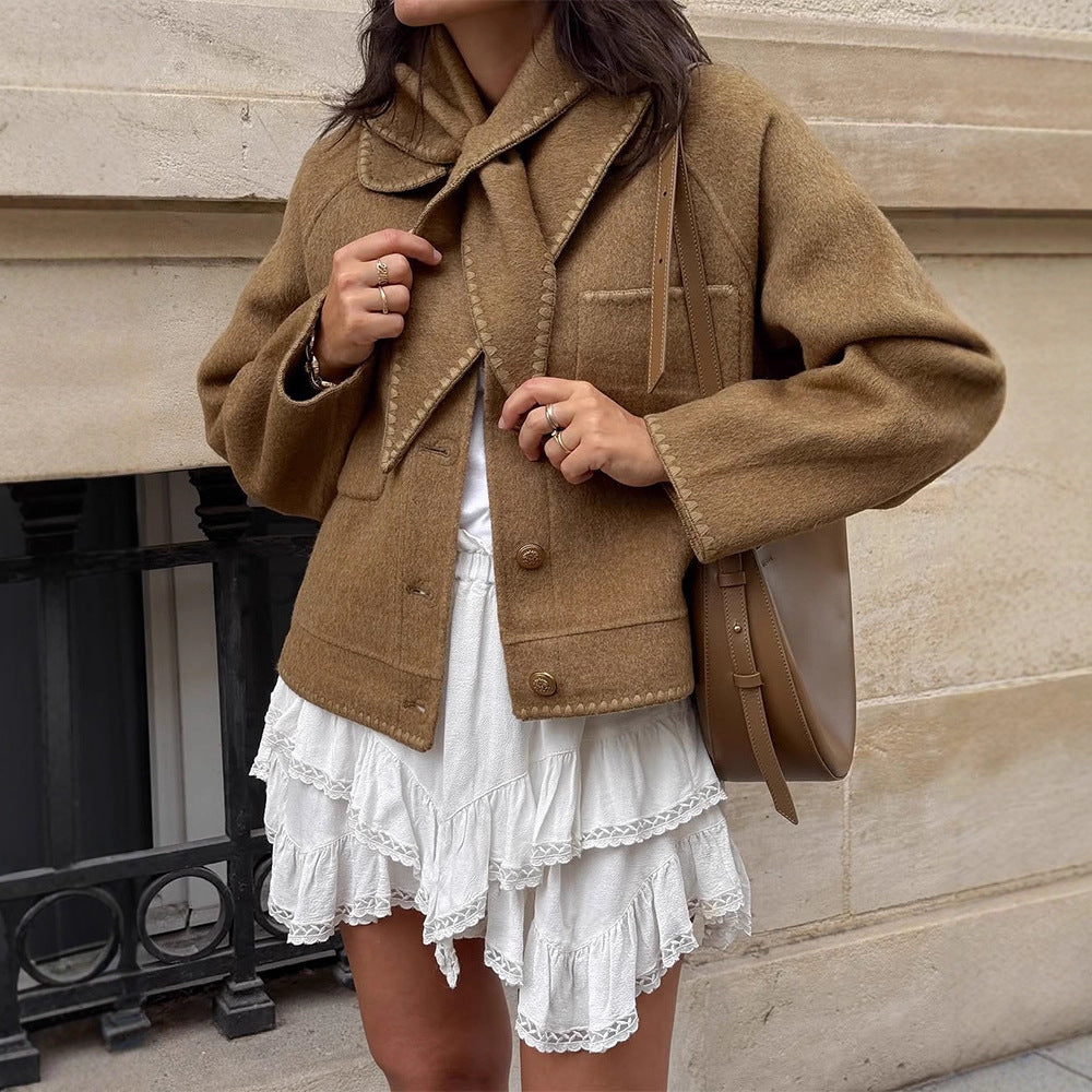 Women's short jacket made of wool blend with a suggested shawl collar, decorative seams, and boxy cropped cut Mune Fashion