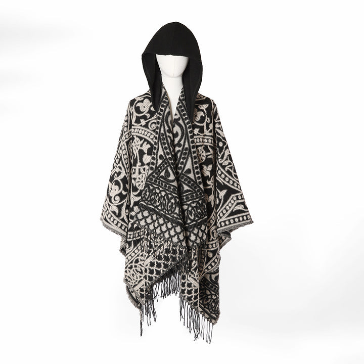 Women’s hooded cape poncho made of wool blend with jacquard pattern, fringes and oversized drape.