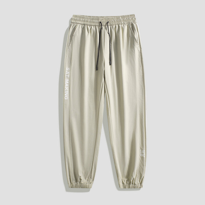 Men's sporty jogging pants with elastic waistband and zippered pockets Mune Fashion