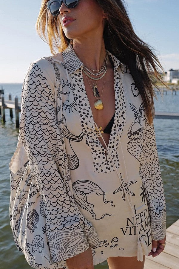 Ladies lightweight beach cover-up in tunic form with deep V-neck, tassel closure, and nautical ocean print Mune Fashion