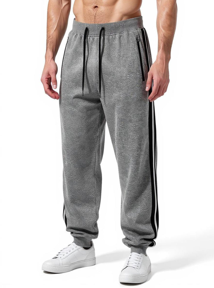 Men's sporty jogging pants with elastic waistband and side zip pockets Mune Fashion