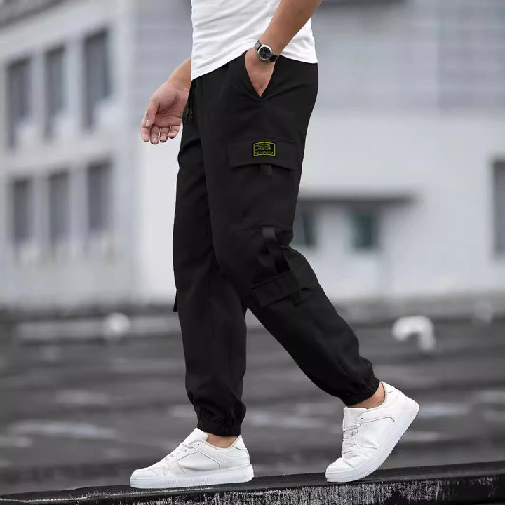 Men's fashionable cargo jogger pants with elastic waistband, drawstring, and multiple security and flap pockets Mune Fashion