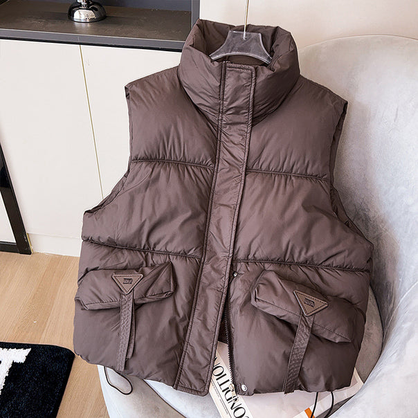 Women’s compact thermo puffer vest with high stand-up collar, concealed front placket, and large utility flap pockets Mune Fashion