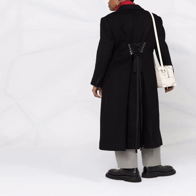 Women’s long coat in minimalist double-breasted style with tailored silhouette and flap pockets Mune Fashion