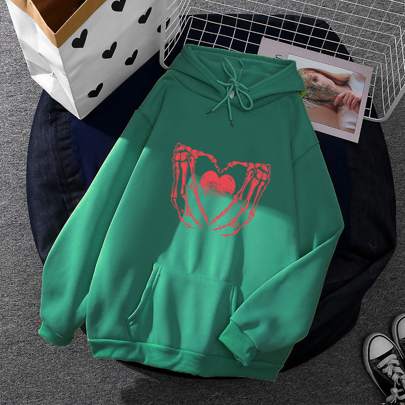 Women's stylish hoodie with skeleton hand heart motif and kangaroo pocket Mune Fashion