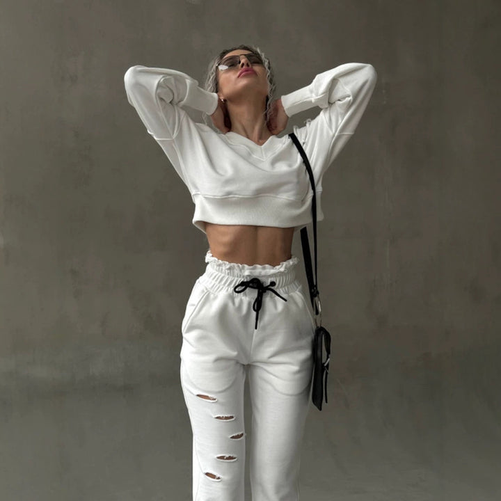 Ladies short-cut sweat set with V-neck, ruffled waistband high-waist joggers and distressed details Mune Fashion