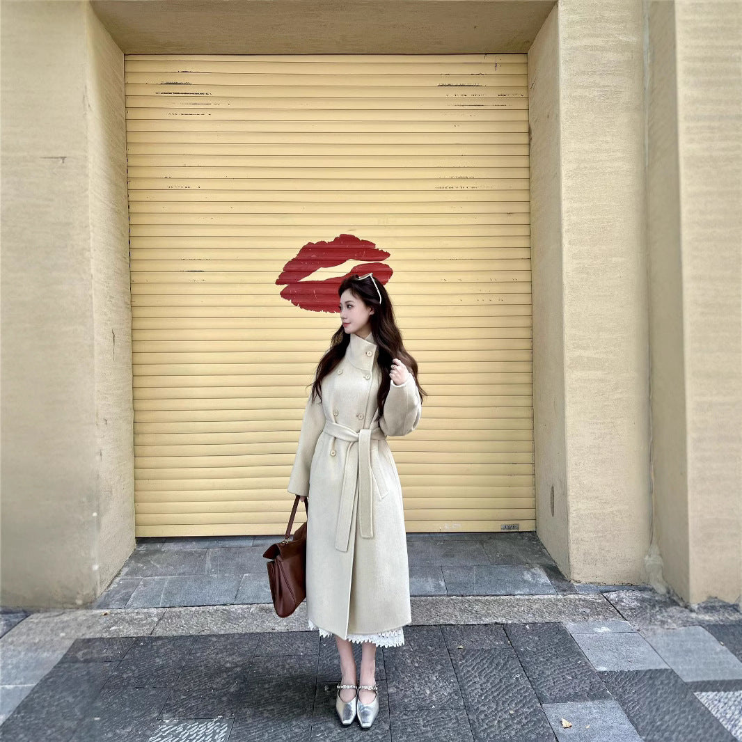 Women’s wool coat with double-breasted button placket, waist belt, and stand-up collar Mune Fashion