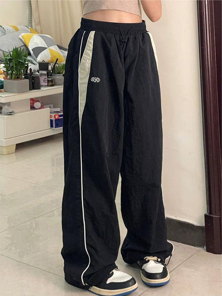 Women's wide track pants with contrast piping, elastic waistband and oversized fit Mune Fashion
