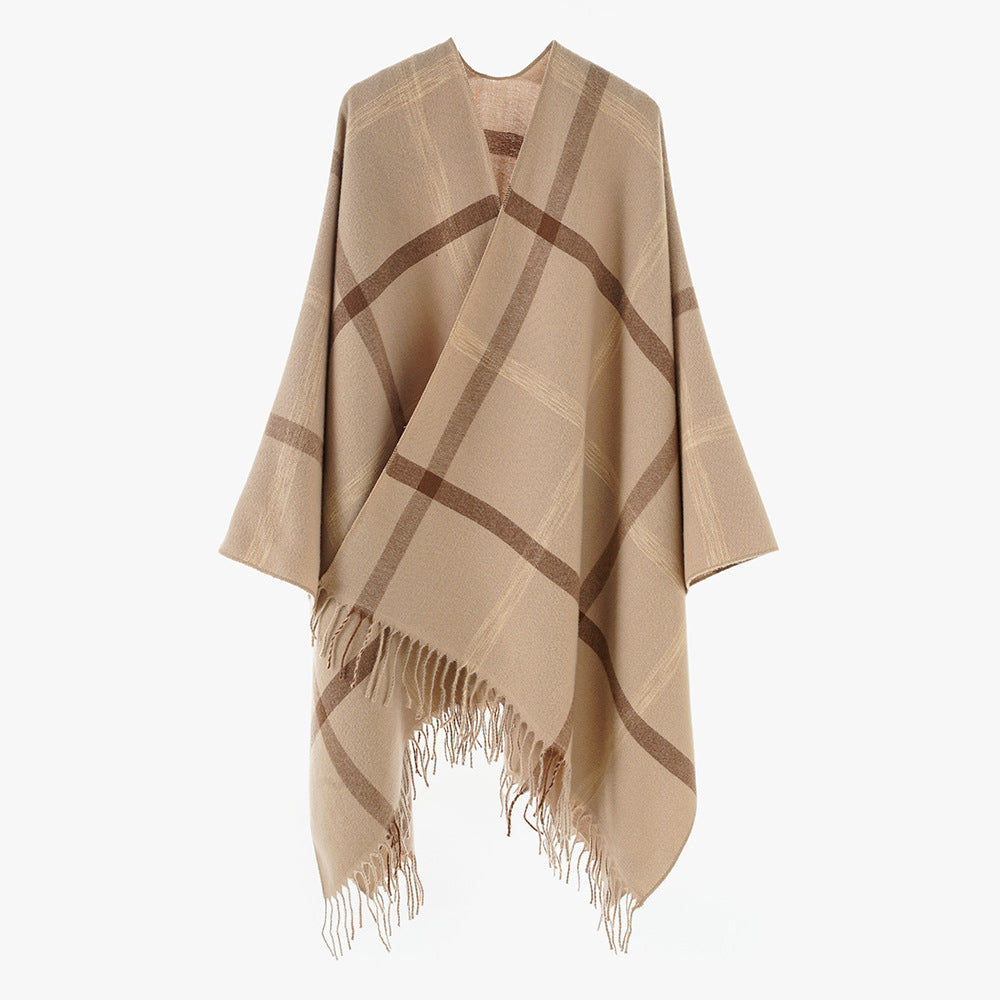 Women's large checkered wool look poncho in cape cut with loose drape and fringes.