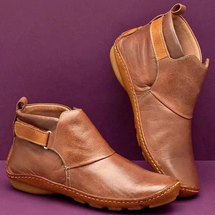 Women's ankle-high slip-on boots made of soft synthetic leather with adjustable hook-and-loop strap and hand-stitched moccasin seam Mune Fashion