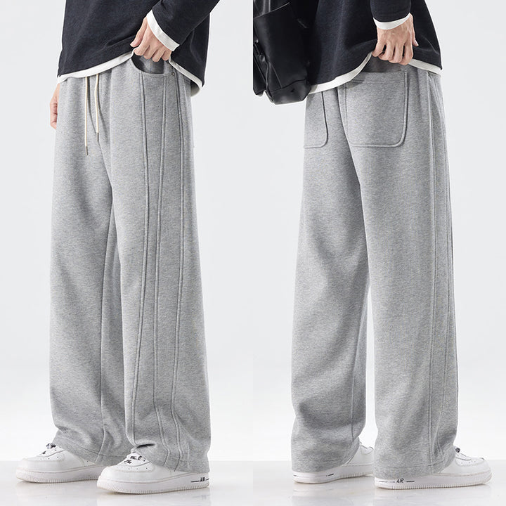 Men's loose sweatpants with decorative seam piping and drawstring
