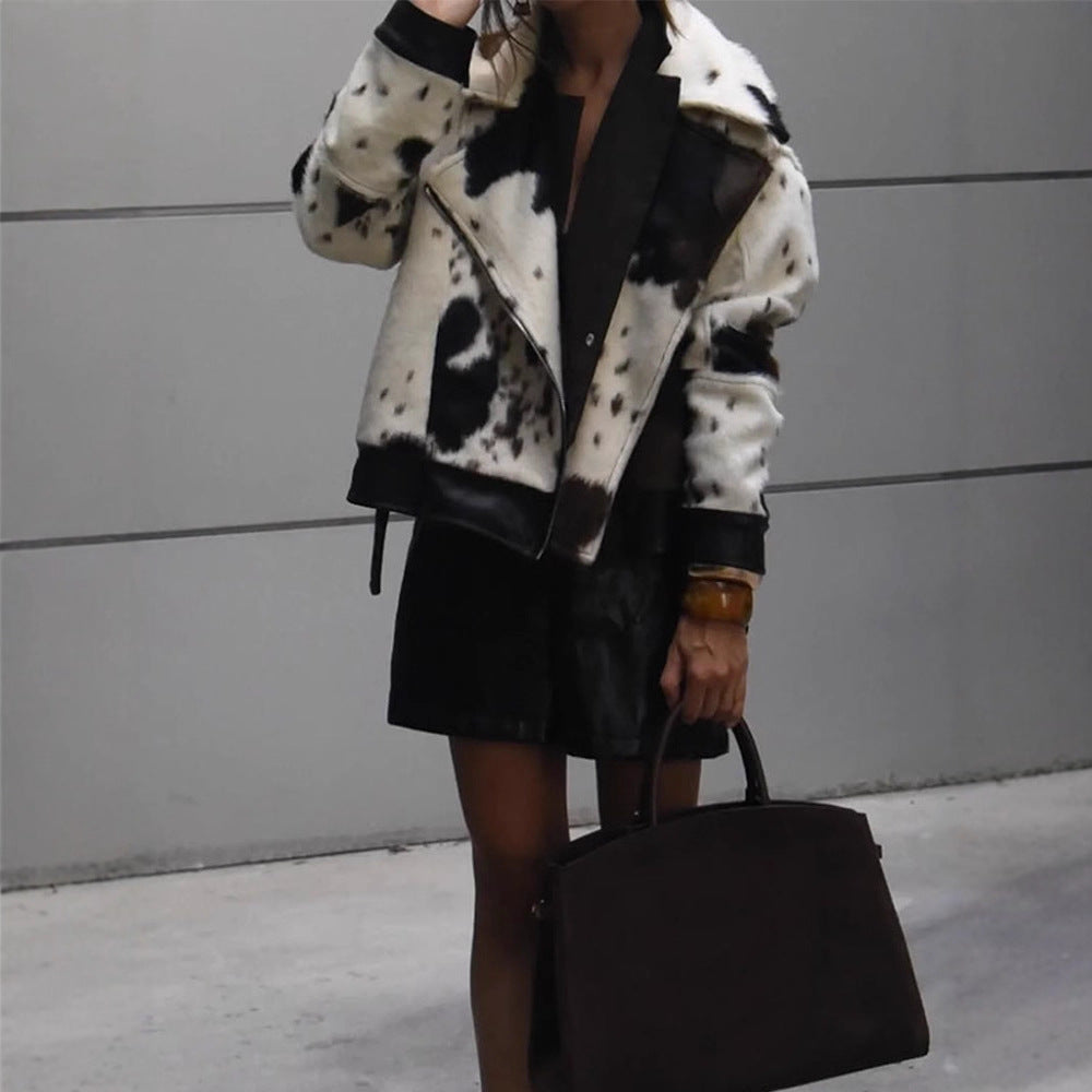 Women short padded biker jacket made of faux fur in cow print with contrast leather trim Mune Fashion