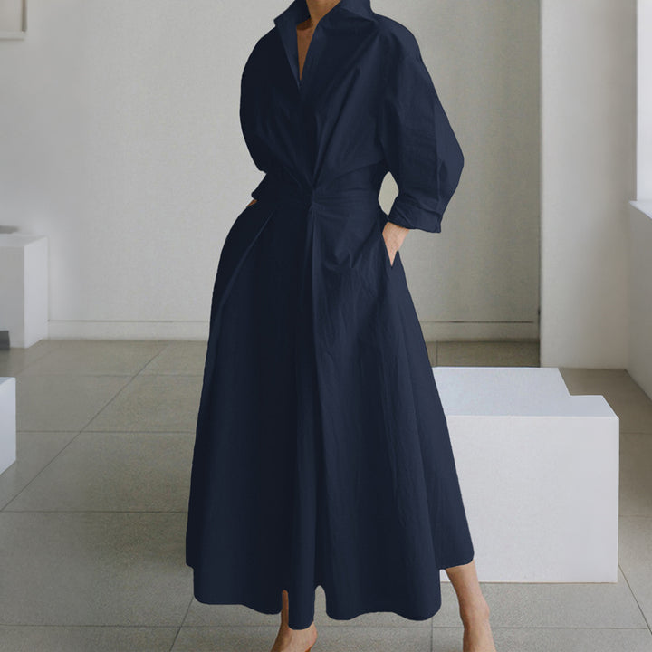 Women's tailored shirt dress with boxy collar, mid-length sleeves, side pockets, and flared pleated skirt Mune Fashion