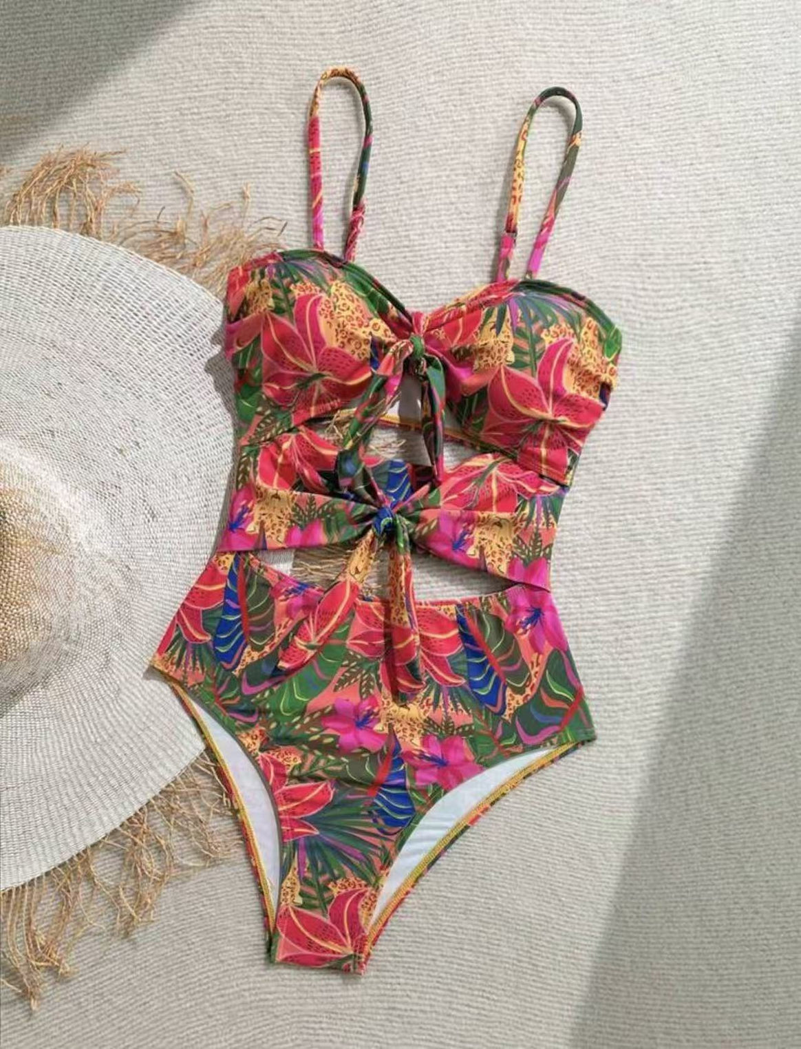 Women's one-piece swimsuit with decorative knot detail and playful floral design Mune Fashion