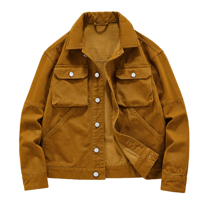 Men's short worker jacket made of heavy twill with applied flap pockets, slanted side pockets, and reinforced seams.