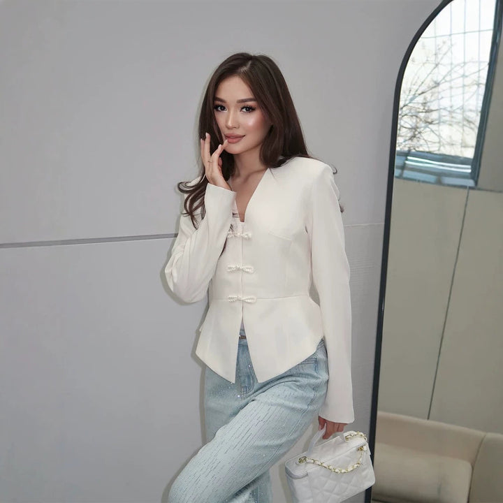 Women's peplum blazer with mandarin-like neckline and decorative knot fastenings Mune Fashion