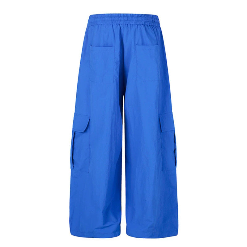 Women's wide palazzo cargo pants with elastic drawstring waistband, large flap pockets, and statement writing print Mune Fashion