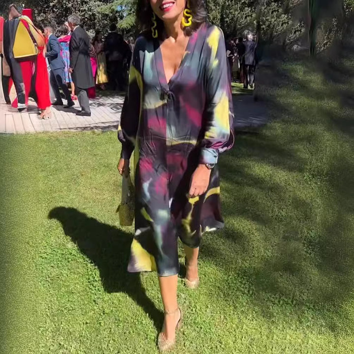 Women's flowing midi dress with abstract print, V-neckline, balloon sleeves, and decorative closure Mune Fashion