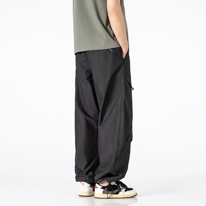 Men's loose-fitting nylon cargo pants with drawstring waistband and angled utility pockets Mune Fashion
