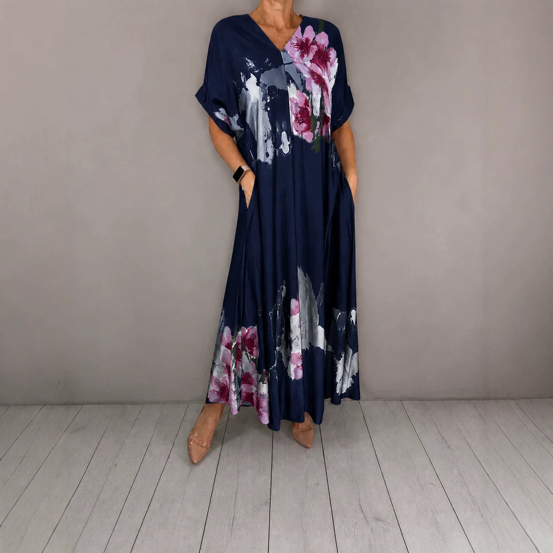 Women's maxi dress with a flowing fall, V-neck, side pockets, and floral watercolor look Mune Fashion