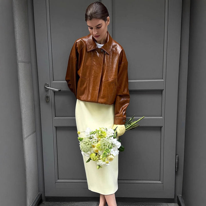 Women's short blazer made of vegan smooth leather with boxy silhouette and concealed snap button placket Mune Fashion