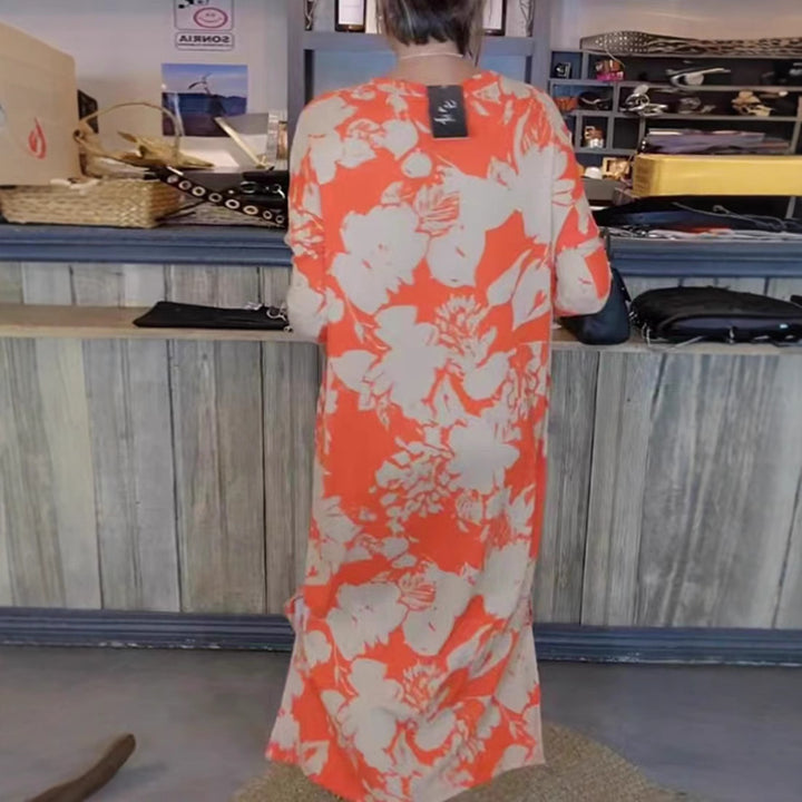 Women’s flowing A-line maxi dress with three-quarter sleeves round neckline side slit and inserted pockets Mune Fashion