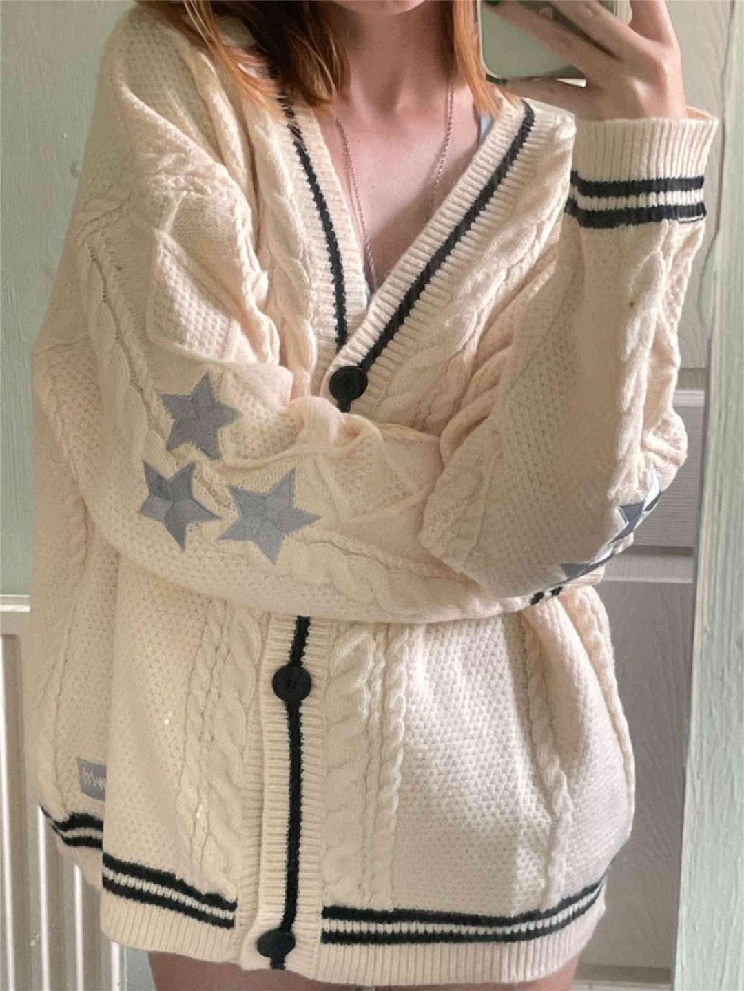 Women's oversized cable knit cardigan with V-neck, button placket and star appliqués Mune Fashion