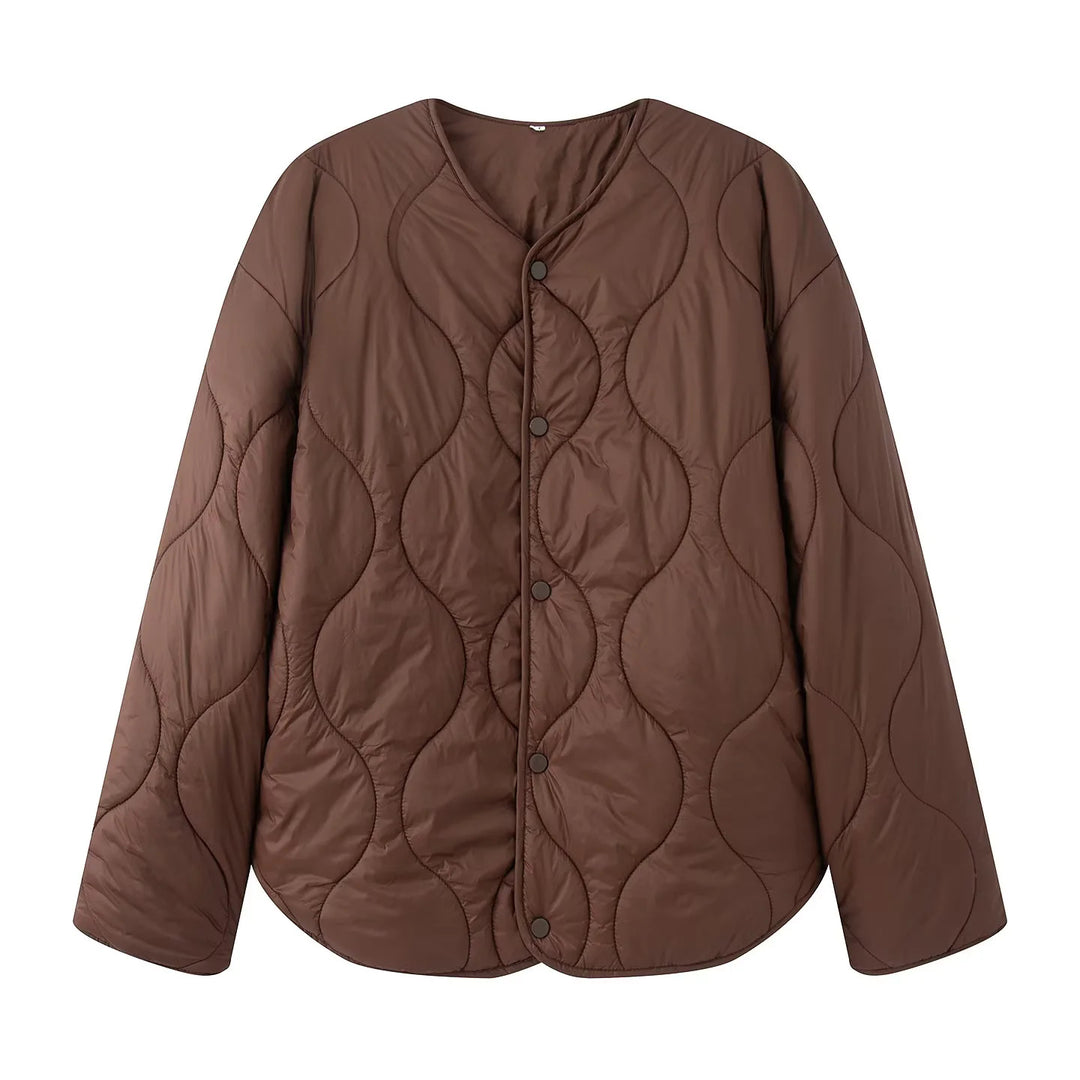 Women's quilted transition jacket with round neckline, snap button closure, and curved hem Mune Fashion