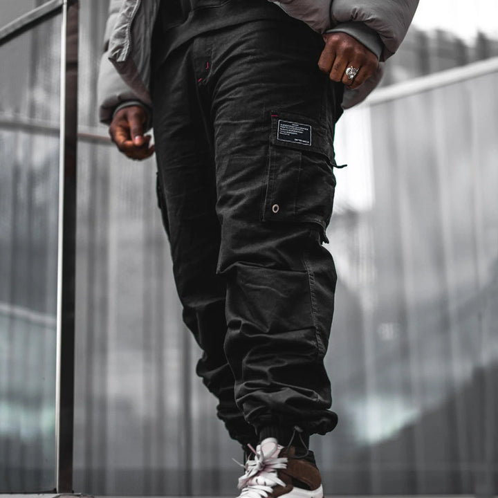 Men's multi-pocket casual trousers made of cotton twill with tapered leg and adjustable ankle drawstring Mune Fashion