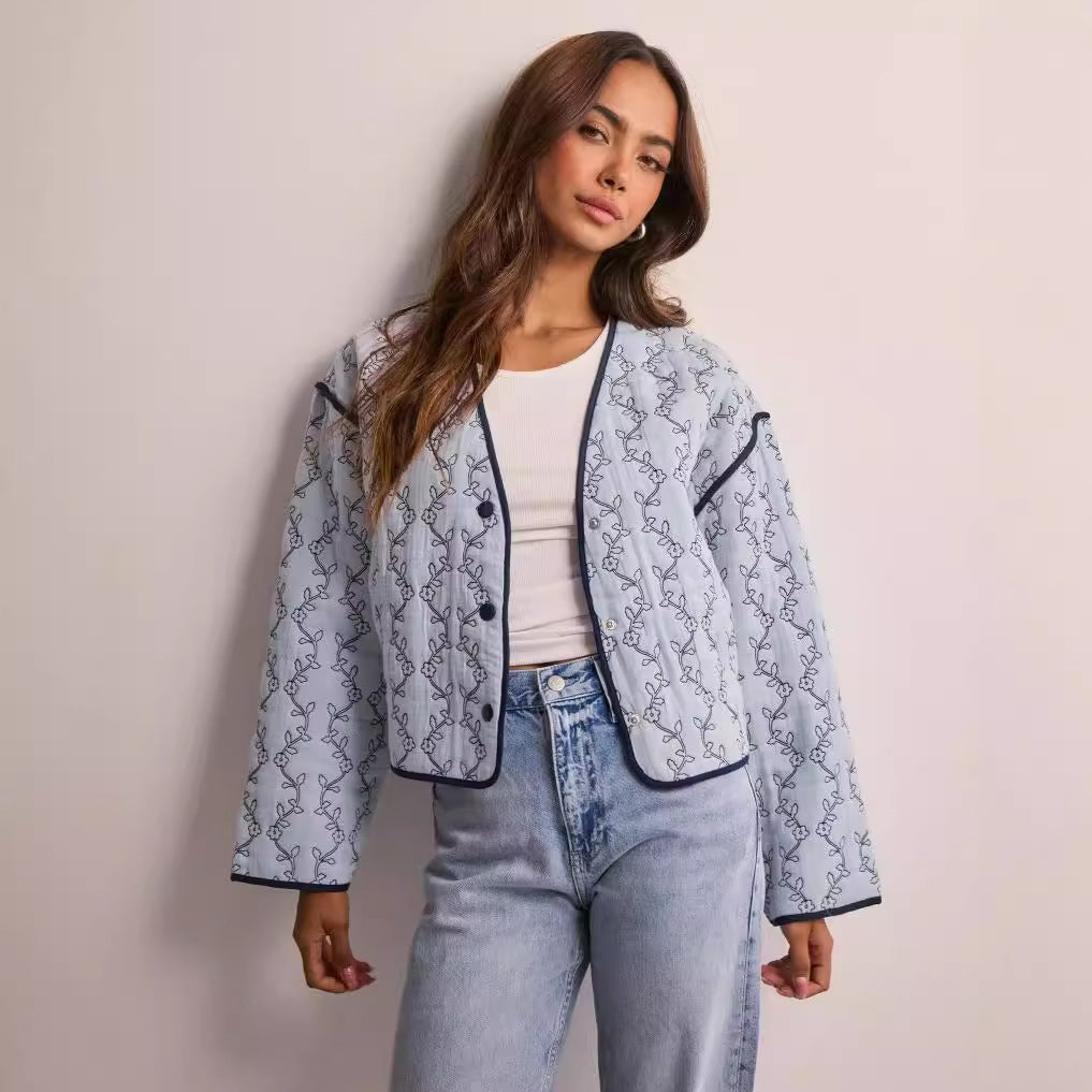 Women's quilted short jacket with V-neck, contrast piping, and floral quilted application Mune Fashion