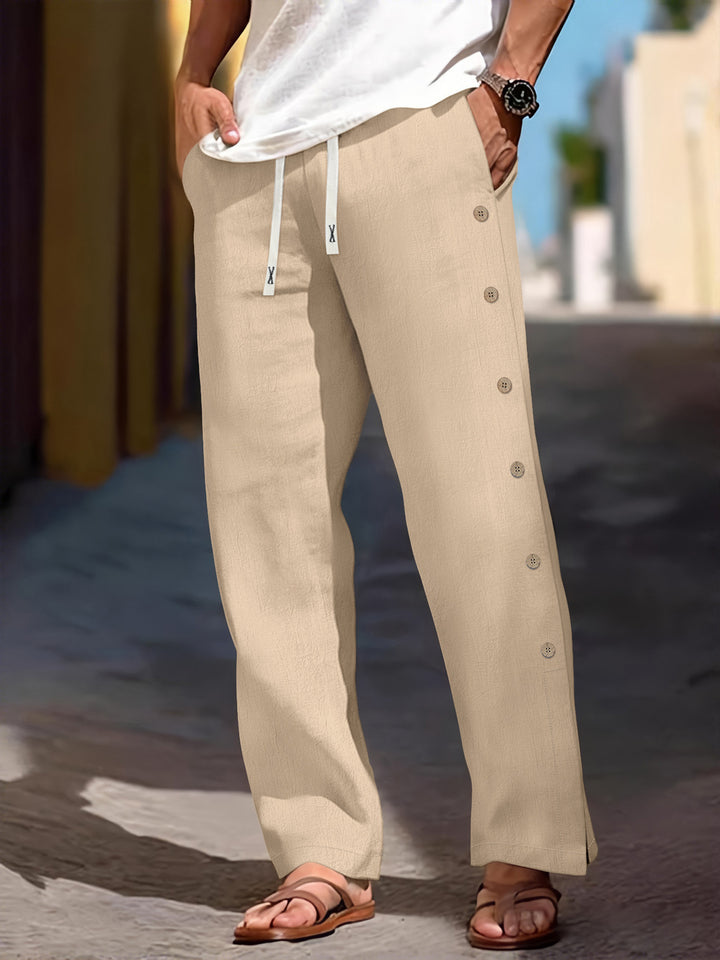 Men's loose leisure pants with side decorative button placket, drawstring waistband, and deep front pockets Mune Fashion
