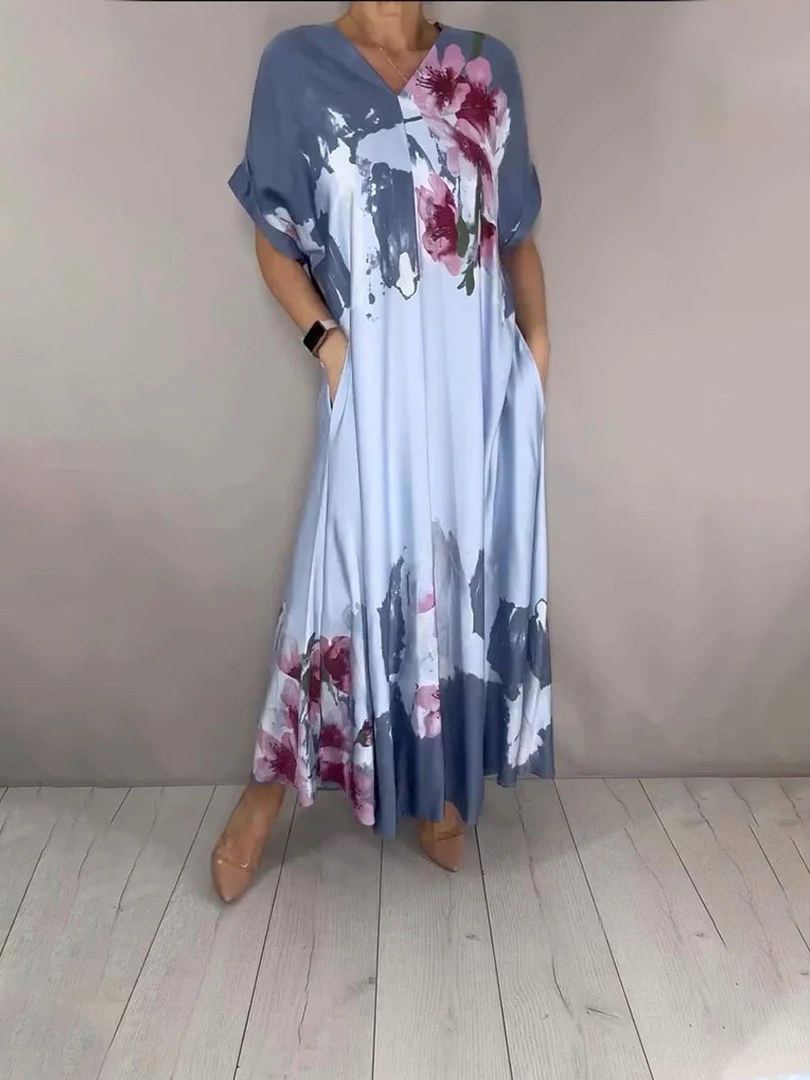 Women's maxi dress with a flowing fall, V-neck, side pockets, and floral watercolor look Mune Fashion
