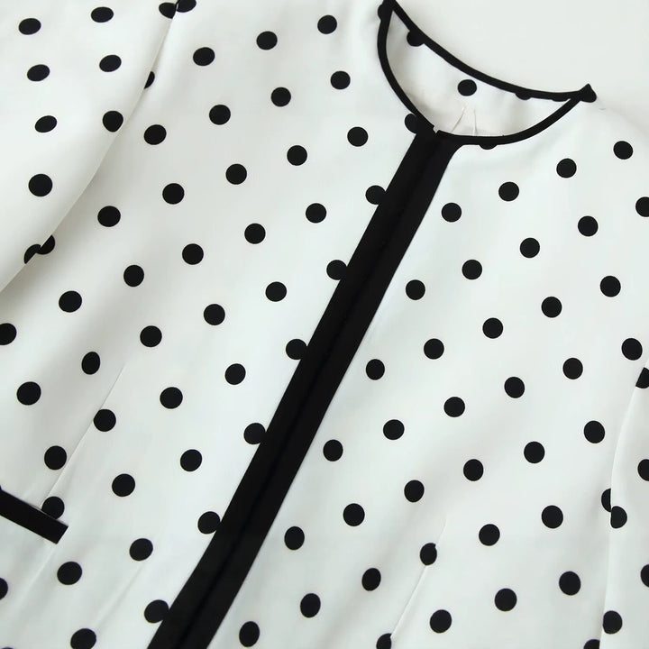 Women's short blazer in polka dot design with black contrast piping and round neck Mune Fashion