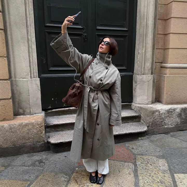 Women’s maxi trench coat with high stand-up collar, double-breasted button placket & waist belt Mune Fashion