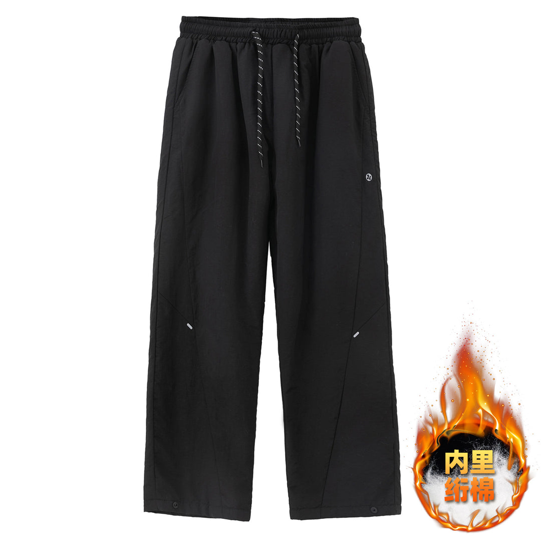 Unisex Wide water-repellent nylon leisure pants with elastic waistband and snap-button hem Mune Fashion