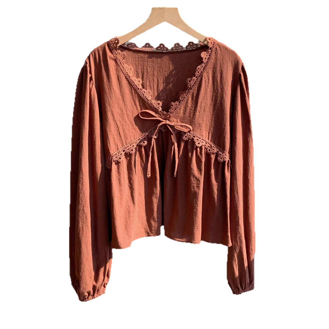 Women’s short blouse with empire cut, V-neck, lace trim, and tie bow Mune Fashion